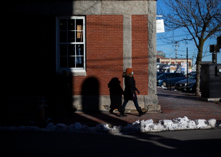 A woman walks past a shop on Union Street in the Old Port on Dec. 7.