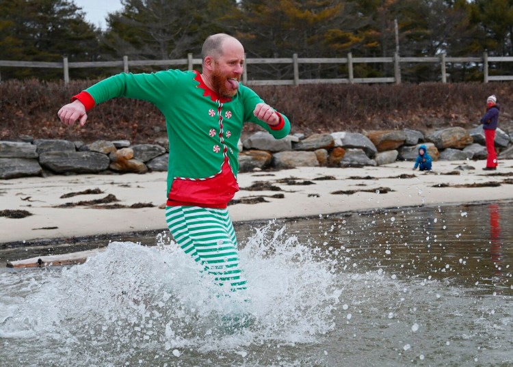 Colin Durrant, spokesperson for the Natural Resources Council of Maine runs into the ocean at Winslow Park in Freeport as part of the 13th annual NRCM Polar Bear Dip & Dash that has gone virtual to benefit climate action in Maine Wednesday, Dec. 30. 