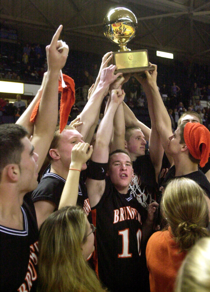 Staff Photo by John Ewing, Saturday, March 16, 2002: Brunswick High School's basketball team took home the gold ball signifying the class A state championship after defeating Deering at the Cumberland County Civic Center.