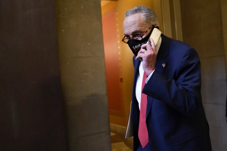 Senate Minority Leader Sen. Chuck Schumer of N.Y., walks on Capitol Hill in Washington, Tuesday.