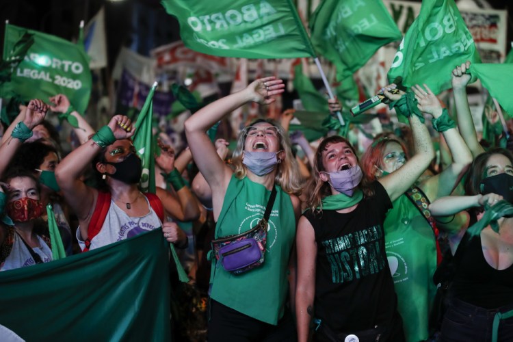 Abortion-rights activists watch a livestream of lawmakers in session, outside the congressional building on Dec. 30, 2020 in Buenos Aires, Argentina. 
