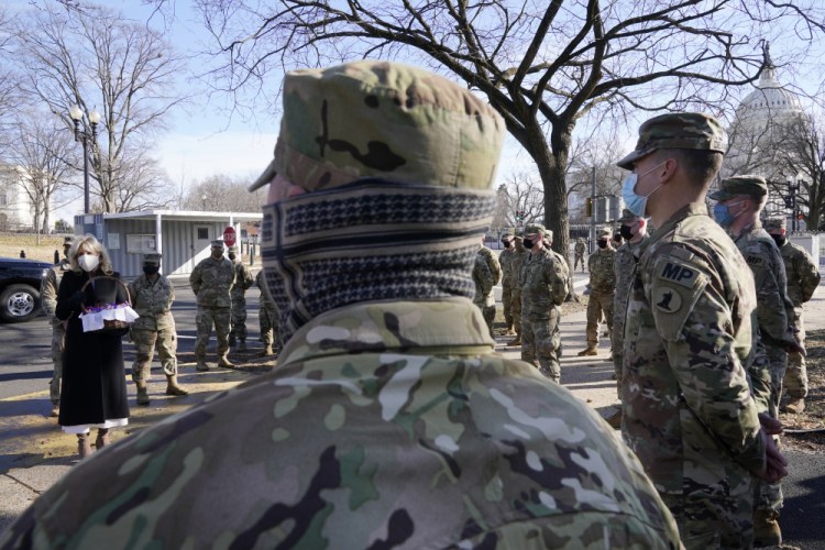 First lady Jill Biden surprises National Guard members outside the U.S. Capitol with chocolate chip cookies on Friday in Washington. Some members of the Maien Guard contingent deployed to D.C. are heading home, but others are going to continue protecting the nation's capital.  