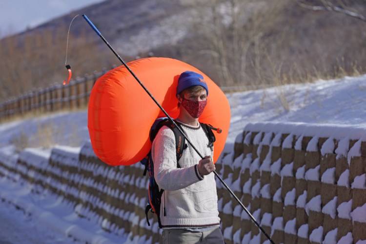 Cameron French of  White Pine Touring wears an Ascent 40 AVABAG avalanche backpack on Dec. 18  in Park City, Utah. With another ski season getting underway, avalanche forecasters and search-and-rescue groups are concerned that large numbers of skiers and snowboarders will again turn to the backcountry to avoid crowds and reservation systems at resorts. The increased interest in the backcountry has been a lifeline for the outdoor retail industry amid the pandemic, but it has also renewed a push among gear manufacturers and stores to sell responsibly. 