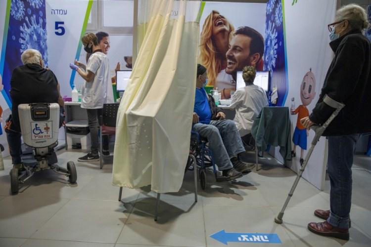 Israelis receive the second Pfizer-BioNTech COVID-19 vaccine in Netanya, Israel, on Jan. 1. Israel has struck a deal with Pfizer, promising to share vast troves of medical data with the drugmaker in exchange for the continued flow of its COVID-19 vaccine.