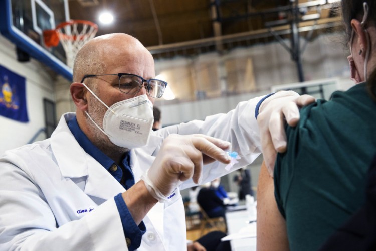University of Scranton nursing student Glen Johnson administers the Moderna COVID-19 vaccine to a medical professional during a clinic at the Throop Civic Center in Throop, Pa. on Saturday. The Lackawanna County Medical Society had about 400 doses of the Moderna vaccine on hand to administer to people in Pennsylvania's Phase 1A group of the vaccine rollout plan, which is limited to healthcare personnel and long-term care facility residents.