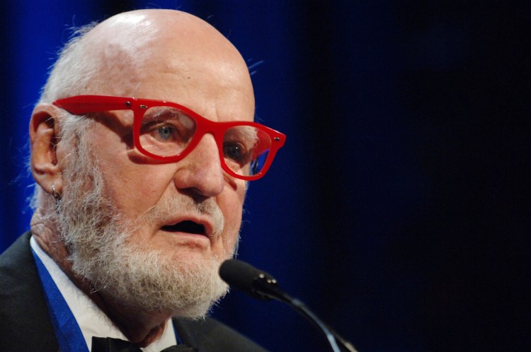 FILE - In this Nov. 16, 2005 file photo, author Lawrence Ferlinghetti reads a poem after he was awarded the Literarian Award for Outstanding Service to the American Literary Community at the National Book Awards in New York. Ferlinghetti, one of the last links to the early days of the Beat poetry movement, never doubted the artistry of Bob Dylan or his worthiness of the Nobel prize.  Ferlinghetti said that decades ago he had hoped the singer-songwriter would release his material in print form. (AP Photo/Henny Ray Abrams, File)