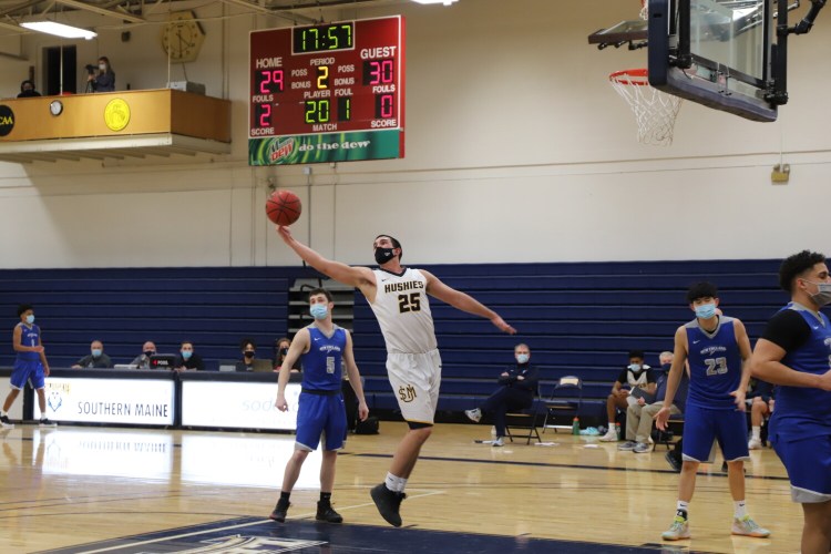 University of Southern Maine forward Marcus Christopher grabs a rebound during a game against the University of New England on Feb. 21 in  Gorham. 