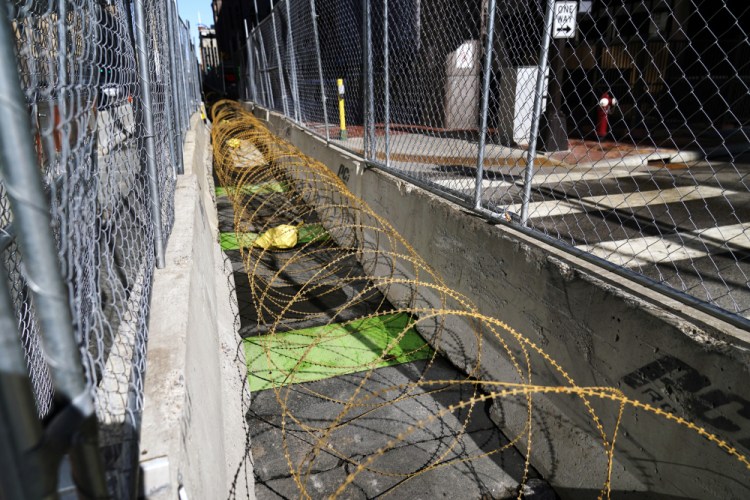 Concertina wire sits between fenced barriers outside the Hennepin County Government Center, Wednesday in Minneapolis, as part of security in preparation for the trial of former Minneapolis police officer Derek Chauvin. The trial is slated begin with jury selection on March 8. Chauvin is charged with murder the death of George Floyd during an arrest last May in Minneapolis.