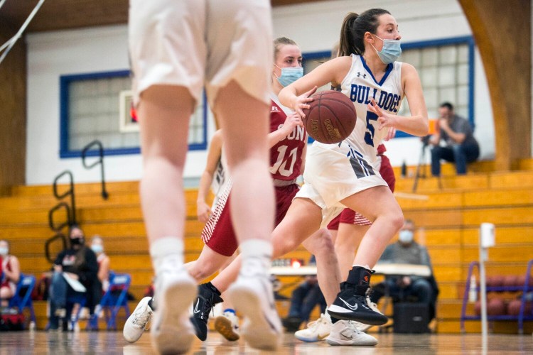Lawrence's MaKenzie Nadeau drives by a Cony defender during a tournament game last March in Fairfield. MaKenzie's basketball career is on hold as she recovers from serious injuries suffered in a Dec. 28 car wreck in Clinton.