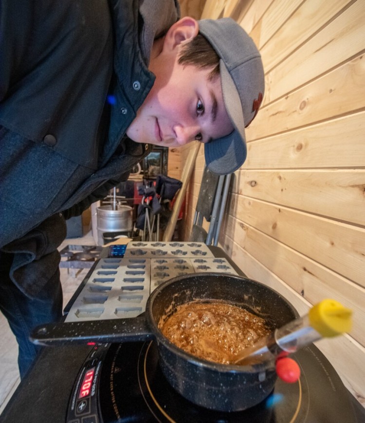 Jayden Palmer keeps an eye Sunday morning on the temperature of the sap he is boiling down to make candy. Living next to Dan Giguere on Old Danville Road in Auburn, who is building a unique, locomotive-style tree house for his sugar shack, Palmer got the itch to tap trees on his family’s property and is learning to make maple syrup, candy and other treats from the longtime maple syrup maker at Rock Maple Mountain Syrup Co. Giguere was not ready to open the tree house operation this year, but had a few items for sale during this year’s Maine Maple Sunday Weekend. Giguere and Palmer are hopeful they will be able to fully open the unique sugar shack next year, with big plans to offer hands-on learning experiences throughout the season, not just one weekend in March.