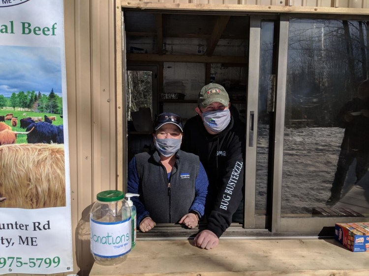 Waterville Area Habitat for Humanity volunteers Karin Warren and Matt Allen inside the warming hut during The Maine Winter Romp.