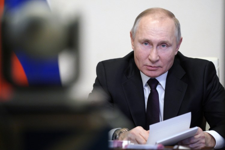 Russian President Vladimir Putin speaks during a meeting March 11 via video conference with officials and Cabinet members in Moscow.