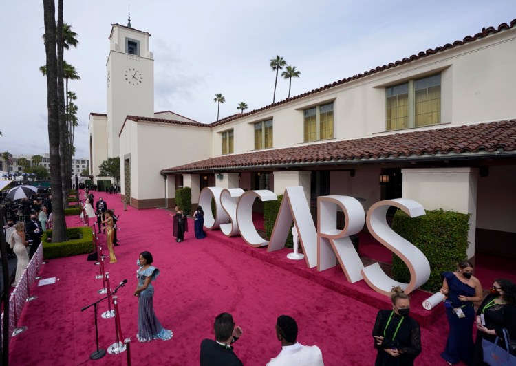 Maria Bakalova, from left, Andra Day and Regina King are interviewed and Marlee Matlin walks the red carpet at the Oscars on Sunday at Union Station in Los Angeles. 