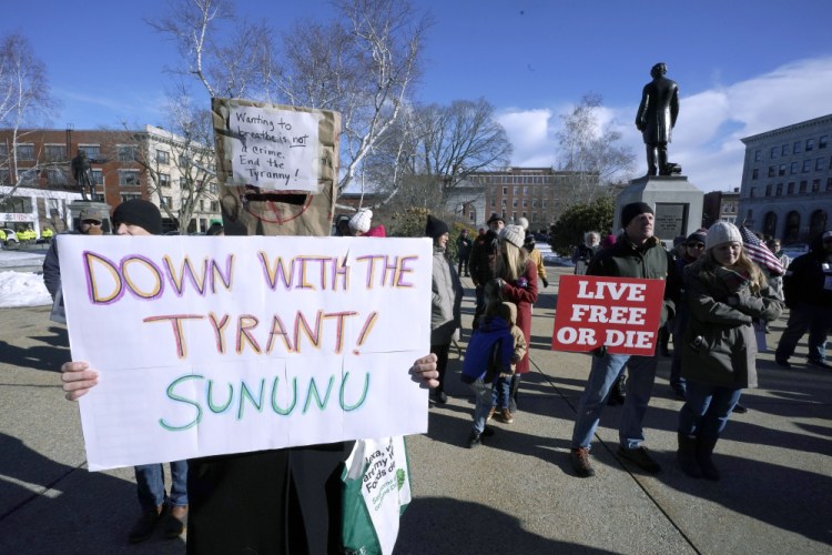 People protest Jan. 7 outside the Statehouse in Concord, N.H., as Gov. Chris Sununu is inaugurated for his third term as governor. A measure that recently passed New Hampshire's Republican-led House would prohibit governors from indefinitely renewing emergency declarations, as Sununu has done every 21 days for the past year. It would halt emergency orders after 30 days unless renewed by lawmakers. 

