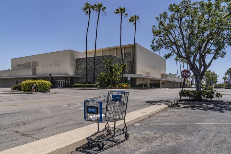An empty shopping cart in an empty parking lot at the closed Sears in Buena Park Mall in Buena Park, Calif. California state lawmakers are grappling with a particularly 21st-century problem: What to do with the growing number of shopping malls and big-box retail stores left empty by consumers shifting their purchases to the web. 

