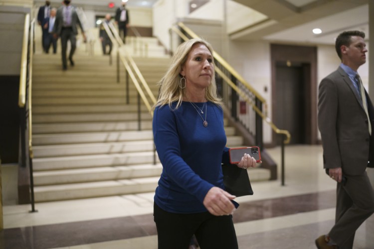 Rep. Marjorie Taylor Greene, R-Ga., and fellow Republicans arrive for a meeting to consider a replacement for Rep. Liz Cheney, R-Wyo., was ousted from the GOP leadership Wednesday at the Capitol in Washington, Thursday, May 13.