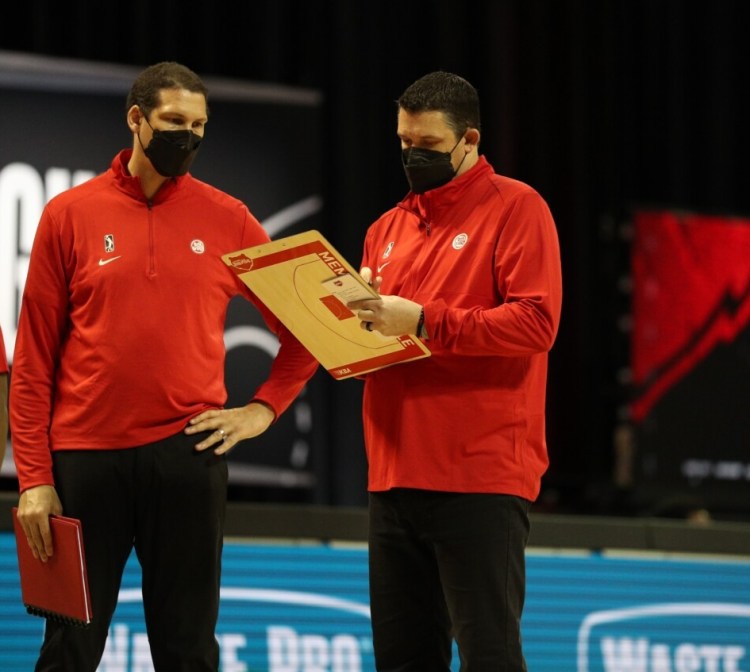 Alex Lloyd, left, talks with a fellow Memphis Hustle coach during a 2020 G-League game. Lloyd is the next Bowdoin men's basketball coach. 