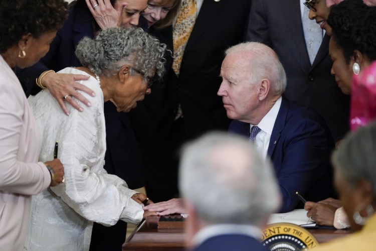 President Biden speaks with Opal Lee after he signed the Juneteenth National Independence Day Act, in the East Room of the White House on Thursday in Washington. 