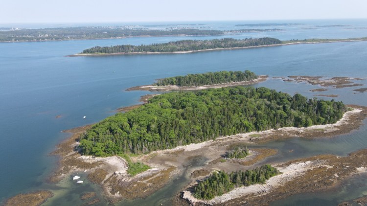 The interconnected mudflats, beaches and ledges that make up Little Whaleboat Island in Harpswell are visible from the air at low tide. (Great) Whaleboat Island and Harpswell Neck are seen in the background. The Maine Coast Heritage Trust has launched a campaign to buy and protect Little Whaleboat for public access, part of an evolving network of preserves it is assembling in Casco Bay.