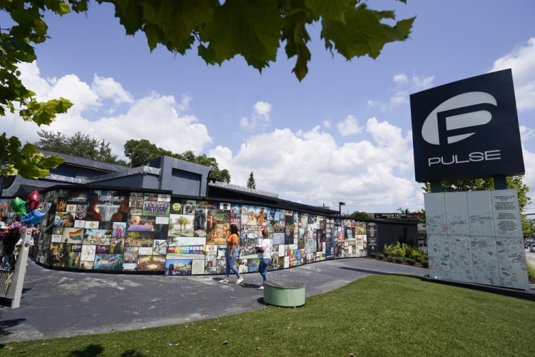 Visitors pay tribute to the display outside the Pulse nightclub memorial Friday in Orlando, Fla. Saturday marks the fifth anniversary of the mass shooting at the site.