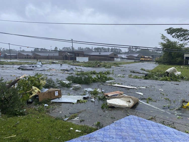 This photo provided by Alicia Jossey shows debris covering the street in East Brewton, Ala., on Saturday, June 19, 2021. Authorities in Alabama say a suspected tornado spurred by Tropical Storm Claudette demolished or badly damaged at least 50 homes in the small town just north of the Florida border.  