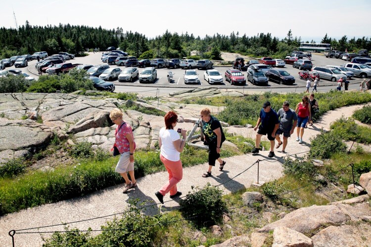 PORTLAND, ME - JULY 16: Park visitors ascend a short path from a parking lot to the summit of Cadillac Mountain, one of the most popular spots in Acadia National Park. Space is so limited in lot that the mountain road is sometimes closed during peak hours. (Staff photo by Ben McCanna/Staff Photographer)