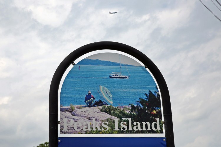 A passenger plane departing from Portland International Jetport flies toward the north end of Peaks Island on Wednesday afternoon.
