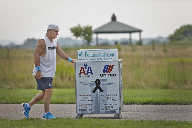 Paul Veneto of Braintree, Mass., is a former flight attendant who lost several colleagues when United Flight 175 was flown into the World Trade Center on Sept. 11, 2001. He is honoring his friends on the 20th anniversary of the attacks. (Greg Derr/The Patriot Ledger via AP)