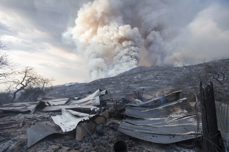 The remains of a  structure burned by a wildfire in Yucaipa, Calif. in 2020.