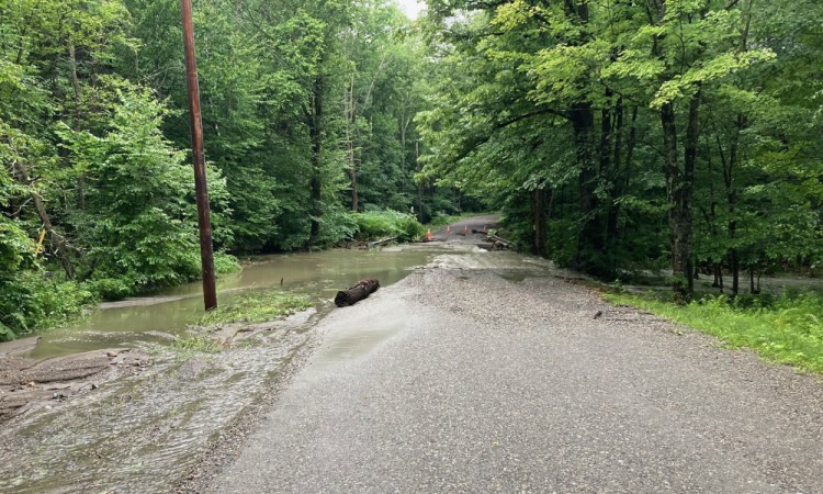 Floodwaters wash out a bridge on Aekly Road in West Brattleboro, Vt., on Saturday.