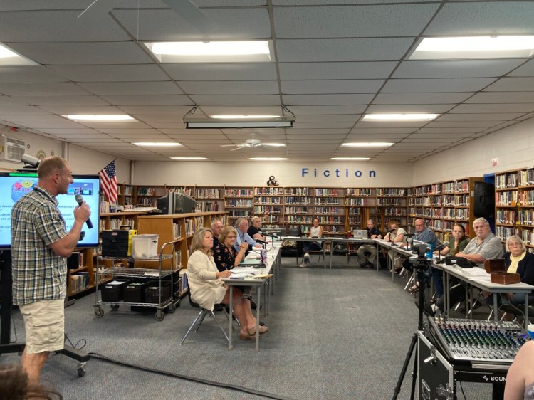 Mountain Valley Middle School Principal Ryan Casey speaks Tuesday to Regional School Unit 10 directors at Mountain Valley High School in Rumford. From left are Secretary Peggy Collette, Superintendent Deb Alden, Directors Greg Buccina of Rumford, Jerry Wiley of Buckfield, Justeen LaPointe of Roxbury, Michelle Casey of Buckfield, Charlie Maddaus of Sumner, Abbey Rice and Bill Hobson, both of Rumford, Bonnie Child of Mexico, Dan Hodge of Rumford, and Gail Parent of Hanover.