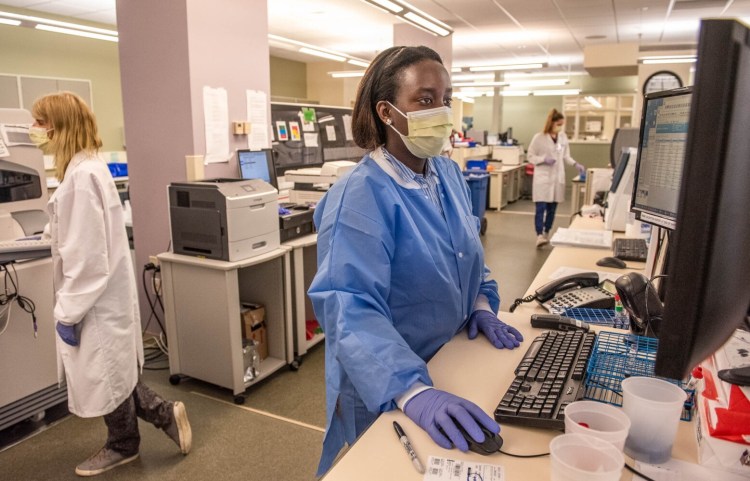 Delicia Nineza, a medical technologist in training, looks Friday for critical lab results that are communicated to Central Maine Medical Center staff providing direct care for patients. The communication system at the Lewiston hospital can help speed up treatment.