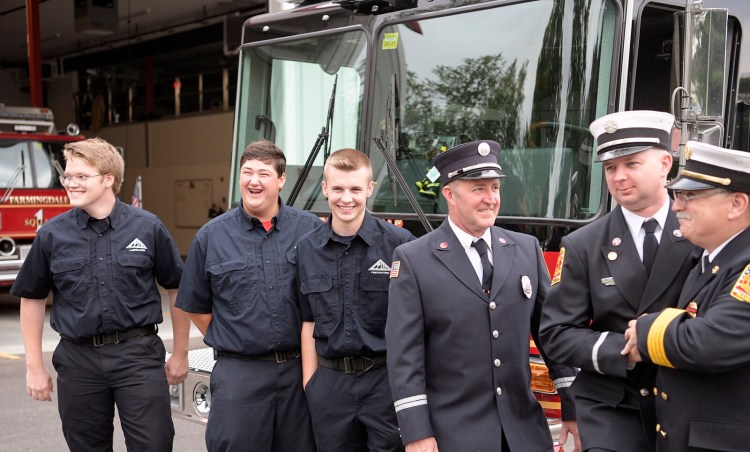 Farmingdale firefighters Zakkary Roy, 17, left, Keegan Bellerose, 16, center, and Aidan Beale, 16, pictured with their officers Michael LaPlante, right, Julian Beale, second from right, and Doug Ebert during a ceremony Tuesday Aug. 10 at the Farmingdale station to celebrate the teenagers' new firefighting credentials.