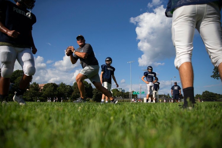 PORTLAND, ME - AUGUST 24: Head coach Jason McLeod demonstrates a drill during Portland High School football practice on Tuesday, Aug. 24, 2021. (Davis/Staff Photographer)