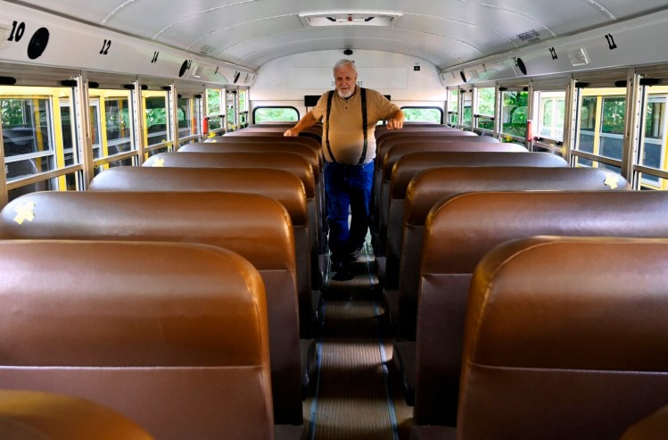 GRAY, ME - AUGUST 25: SAD15 bus driver Tom Hudak makes his pre trip inspection of his bus at the SAD 15 bus garage before driving a sports team to a scrimmage Wednesday, August 25, 2021. Hudak had retired from driving busses with another school district but was encouraged to start driving again a few years ago to help out with the shortage of drivers. (Staff Photo by Shawn Patrick Ouellette/Staff Photographer)