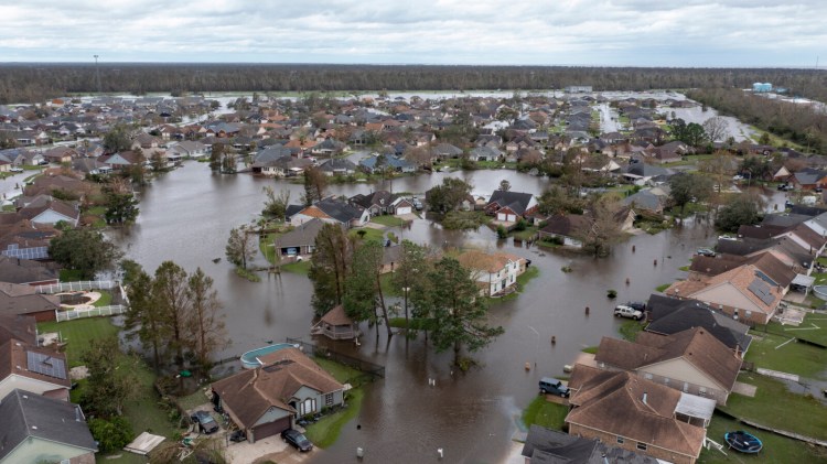 FILE - In this Aug. 30, 2021, file photo flooded streets and homes are shown in the Spring Meadow subdivision in LaPlace, La., after Hurricane Ida moved through. In a season of daunting wildfires and flooding, the Biden administration is taking an initial step to assess how climate change could harm financial markets, planning to launch a 75-day comment period Tuesday, Aug. 31, on how the impacts could reshape the insurance sector. (AP Photo/Steve Helber, File)