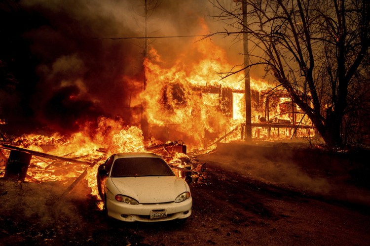 Flames from the Dixie Fire consume a home on Highway 89 south of Greenville on Thursday, Aug. 5, 2021, in Plumas County, Calif. 