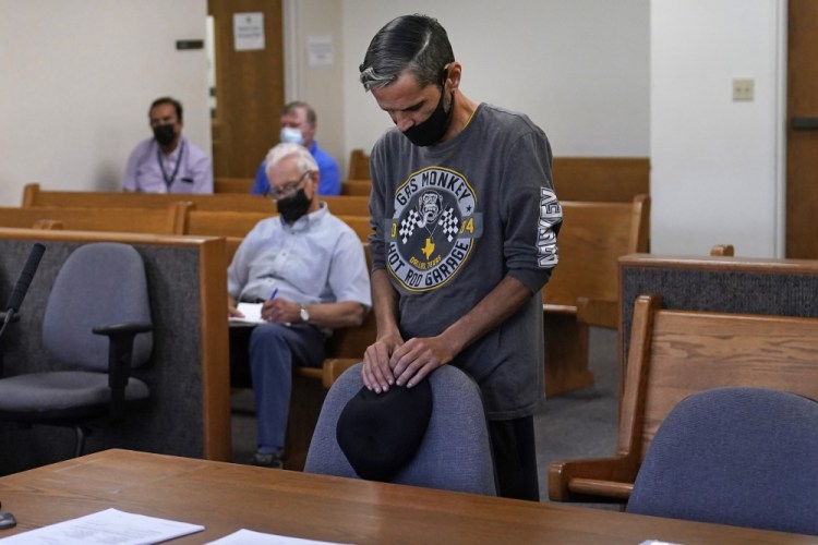 Luis Vertentes, a tenant from East Providence, R.I., stands before Judge Walter Gorman during an eviction hearing on Monday, in Providence. Vertentes agreed to leave his residence, which he has not paid rent on in four months, in about three weeks. “I’m going to be homeless, all because of this pandemic,” he said. “I feel helpless, like I can’t do anything even though I work and I got a full-time job.”