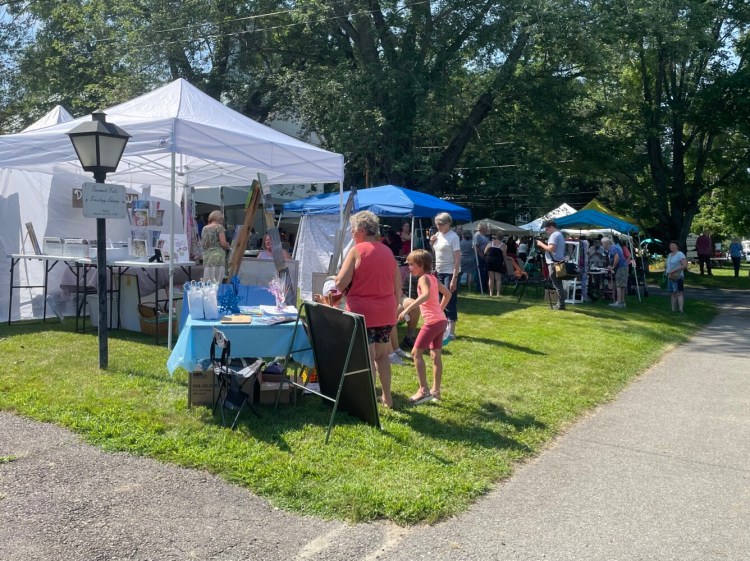 Visitors at the Winslow Blueberry Festival explore the variety of booths during the Saturday event. 