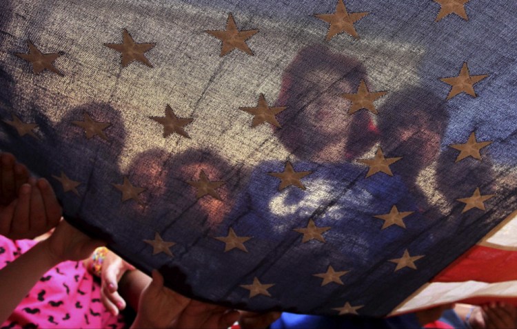 Kellen Savoy, center, helps present the colors as students raise the flag at William Lloyd Meador Elementary School on Sept. 11, 2013, in Willis, Texas. 