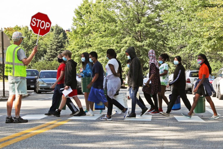 PORTLAND, ME - SEPTEMBER 14: Crossing guard Paul Watson stops traffic on Deering Avenue while King Middle School students return to school from Deering Oaks. (Staff photo by Ben McCanna/Staff Photographer)