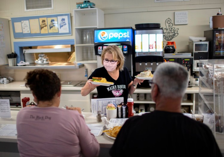 WELLS, ME - SEPTEMBER 3:  Juanita Lucas serves customers at the Maine Diner in Wells on Friday. The restaurant opened Friday after closing for a week because one of its cooks was infected with covid. (Davis/Staff Photographer)