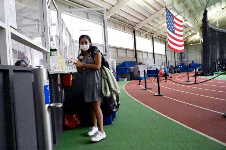 BRUNSWICK, ME - SEPTEMBER 3: Martha Gebeyehu, a Jr. from Boston, Massachusetts sanitizes her hands after taking a Covid testing at Bowdoin's Farley Field House Friday, September 3, 2021. (Staff Photo by Shawn Patrick Ouellette/Staff Photographer)