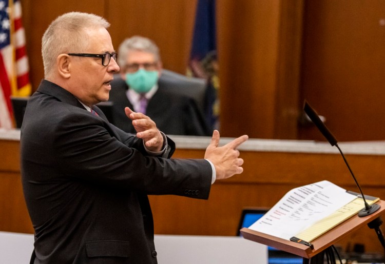 Defense attorney James Howaniec makes a finger gun gesture while describing a  confrontation that ending in a shooting while making opening statement in murder trial of his client Gage Dalphonse Wednesday in the Capital Judicial Center in Augusta.