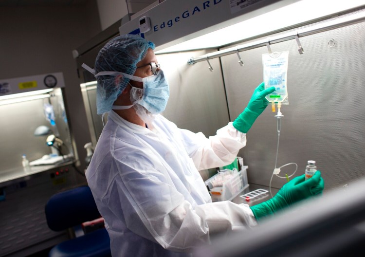 SOUTH PORTLAND, ME - SEPTEMBER 15: Dan Pelletier, a pharmacy technicinan specialist at Maine Medical Center, demonstrates the process of preparing anitibodies used to treat COVID19 patients. (Photo by Derek Davis/Staff Photographer)