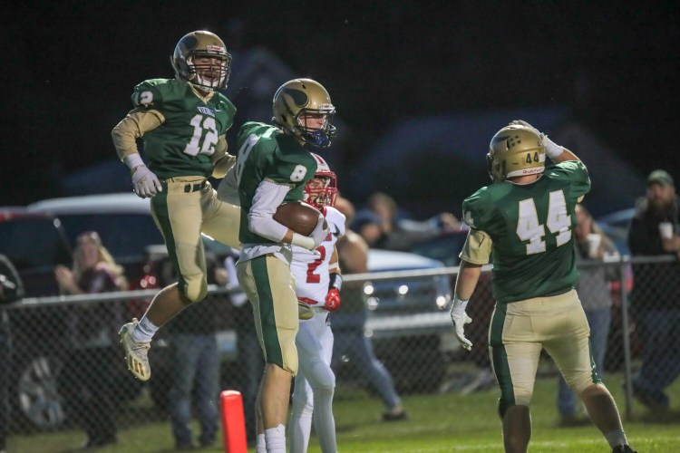 Oxford Hills' Matt Doucette, Teigan Pelletier and Isaiah Oufiero celebrate after scoring a touchdown against Sanford on Sept. 10.