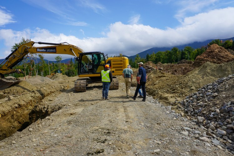 A crew walks land for a new 22-unit A-frame housing project called  Parmachenee Village at Saddleback Mountain, currently under construction.