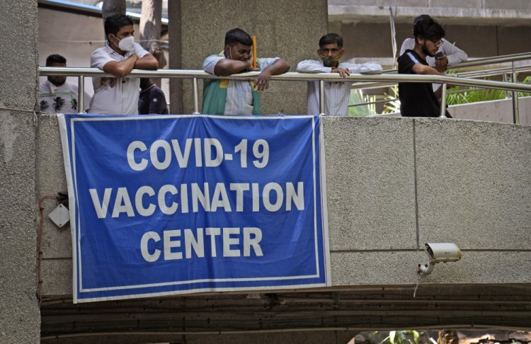 People watch others arrive to receive the COVID-19 vaccine at a government-run hospital in New Delhi, India, Tuesday, Sept. 21, 2021. Travelers and authorities from India and many African countries are furious — and confused — about Britain's new COVID-19 travel rules, calling them discriminatory, as experts warn the measures could fuel misinformation about vaccines in countries in some of the world's least vaccinated countries. 