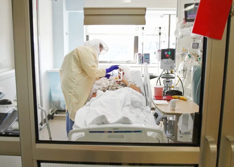 In this screen capture from a Maine Medical Center video posted on their Facebook page on September 3, an ICU nurse cares for a COVID-19 patient at Maine Medical Center in Portland. (Screen capture from Maine Medical Center video)