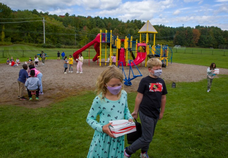 WESTBROOK, ME - OCTOBER 1: Shaelyne Gallagher, 9, and Carter Anderson, 9, 4th graders at the Congin Elementary School in Westbrook, at lunch outside on Friday.  Across the country, labor shortages and disruptions in the supply chain are leaving schools scrambling to adjust as they try to feed the children who returned to classrooms this fall. (Staff Photo by Michele McDonald/Staff Photographer)